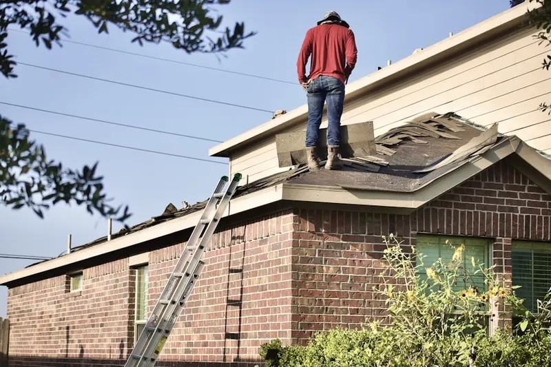 Professional roofer working on a residential roof in West Jordan East